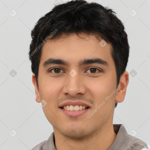 Joyful latino young-adult male with short  brown hair and brown eyes