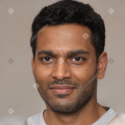 Joyful black young-adult male with short  black hair and brown eyes