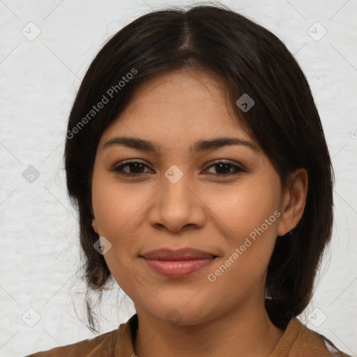 Joyful latino young-adult female with medium  brown hair and brown eyes