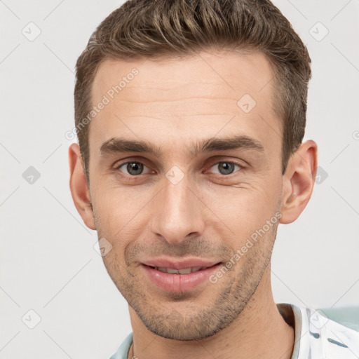 Joyful white young-adult male with short  brown hair and brown eyes