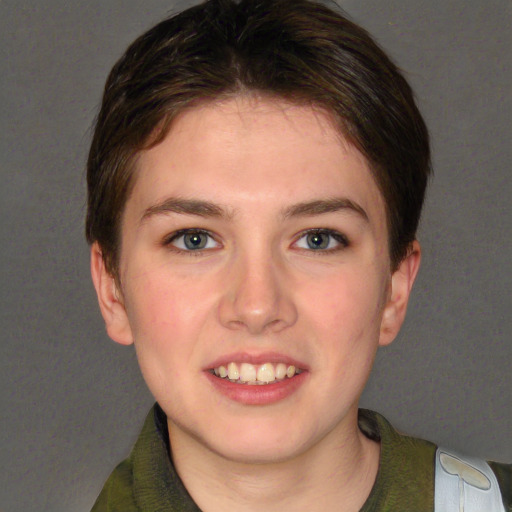 Joyful white young-adult female with short  brown hair and green eyes