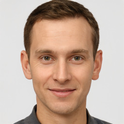 Joyful white adult male with short  brown hair and grey eyes