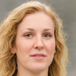 Joyful white young-adult female with medium  brown hair and blue eyes