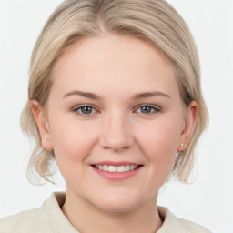 Joyful white young-adult female with medium  brown hair and blue eyes