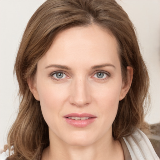 Joyful white young-adult female with long  brown hair and blue eyes