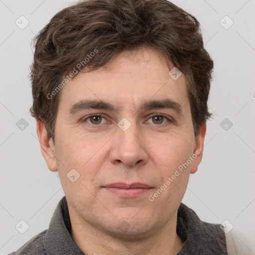 Joyful white adult male with short  brown hair and grey eyes