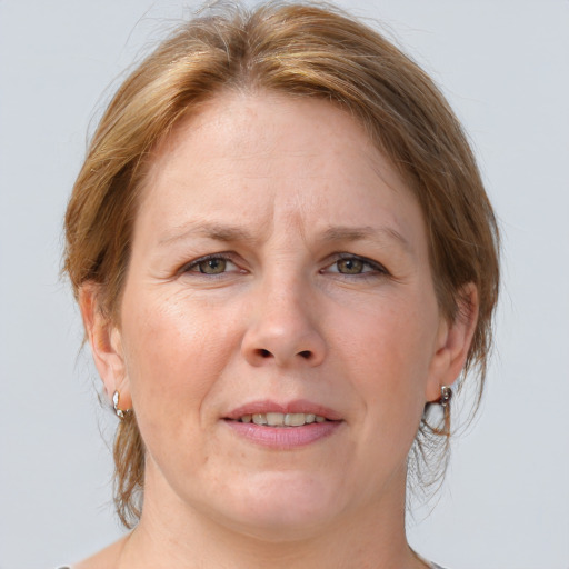 Joyful white adult female with medium  brown hair and grey eyes