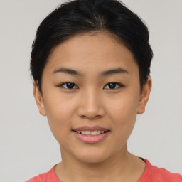 Joyful asian young-adult female with short  brown hair and brown eyes