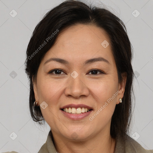 Joyful asian adult female with medium  brown hair and brown eyes