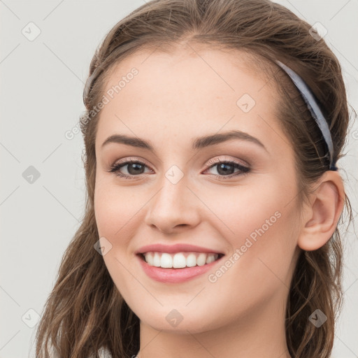 Joyful white young-adult female with long  brown hair and grey eyes