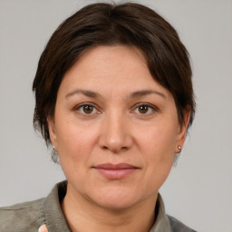 Joyful white adult female with short  brown hair and grey eyes