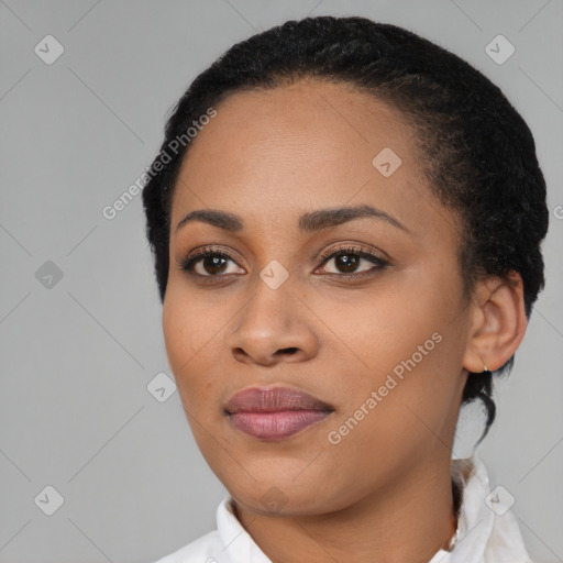 Joyful black young-adult female with short  black hair and brown eyes