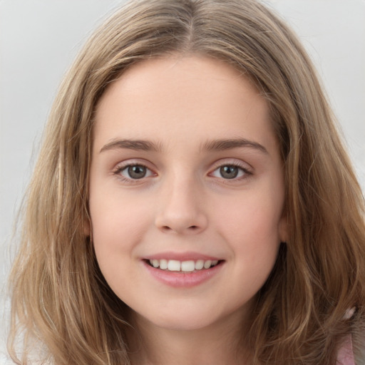 Joyful white child female with long  brown hair and brown eyes