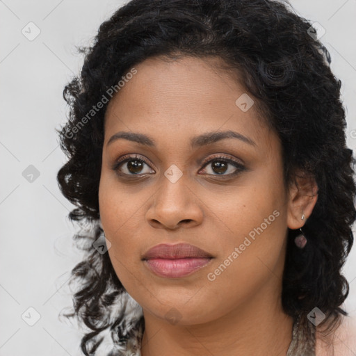 Joyful black young-adult female with long  black hair and brown eyes