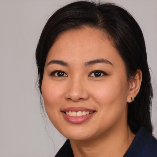 Joyful asian young-adult female with long  brown hair and brown eyes