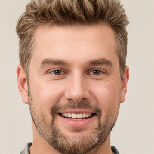 Joyful white adult male with short  brown hair and brown eyes