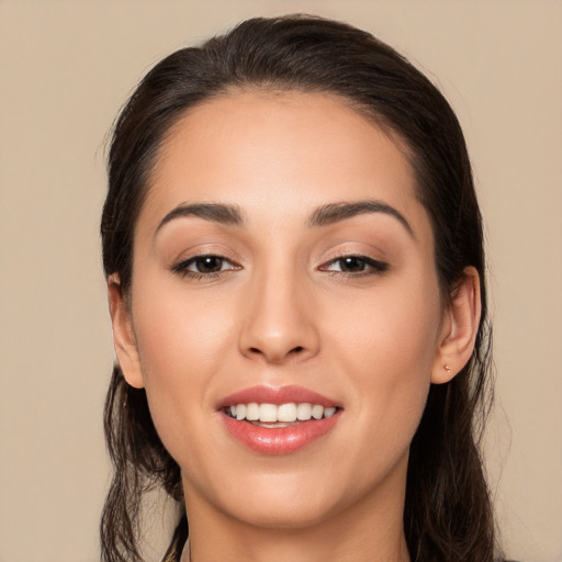 Joyful white young-adult female with long  brown hair and brown eyes