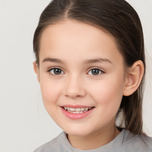 Joyful white child female with medium  brown hair and brown eyes