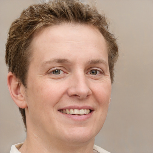 Joyful white adult female with short  brown hair and grey eyes