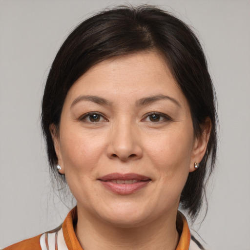 Joyful white adult female with medium  brown hair and brown eyes