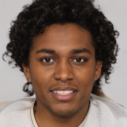 Joyful black young-adult male with short  brown hair and brown eyes