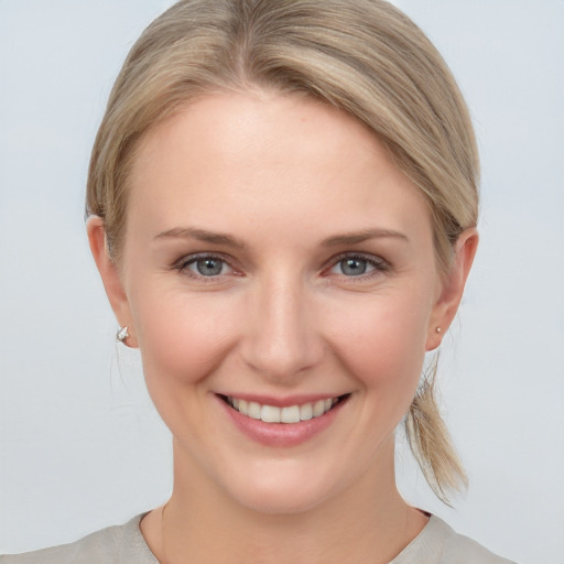 Joyful white young-adult female with medium  brown hair and grey eyes