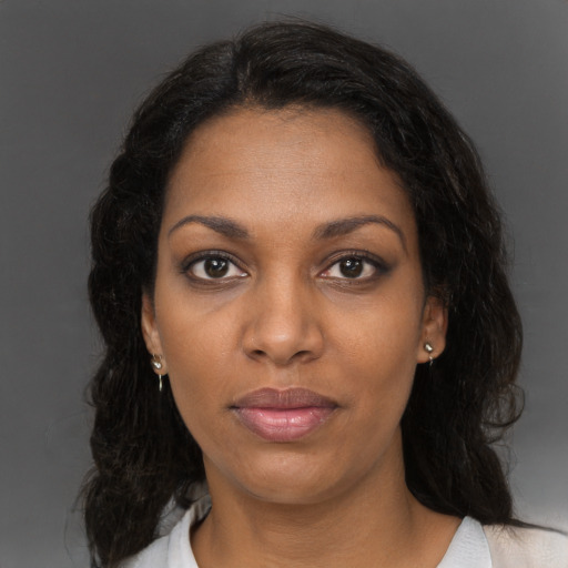 Neutral black young-adult female with medium  brown hair and brown eyes