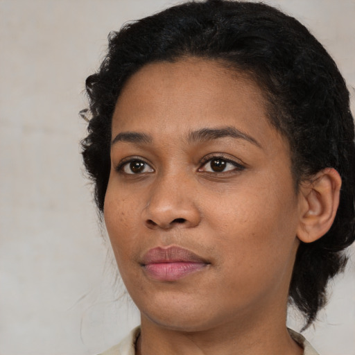 Joyful black young-adult female with medium  brown hair and brown eyes
