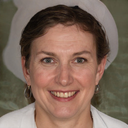 Joyful white adult female with medium  brown hair and grey eyes