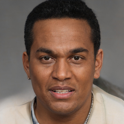 Joyful black young-adult male with short  black hair and brown eyes