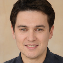 Joyful white young-adult male with short  brown hair and brown eyes