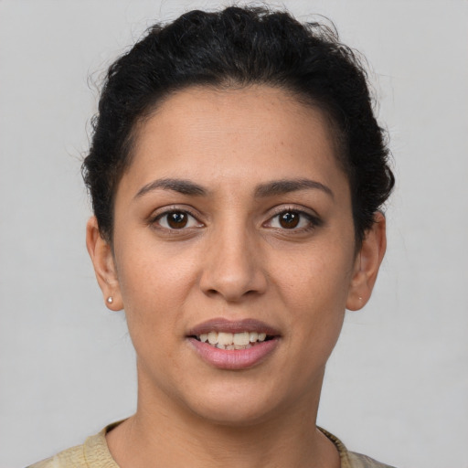 Joyful white young-adult female with short  brown hair and brown eyes