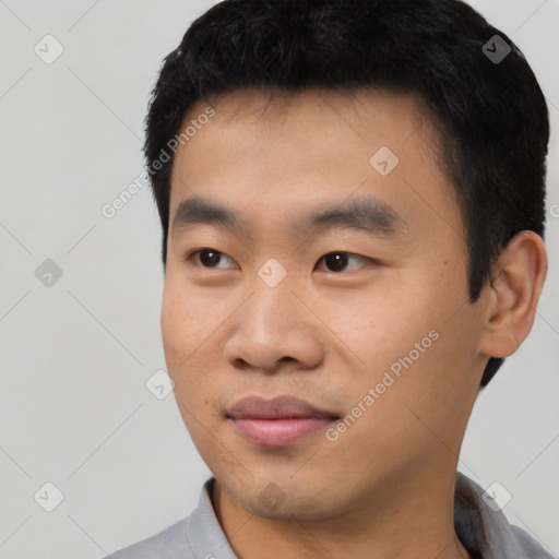 Joyful asian young-adult male with short  black hair and brown eyes