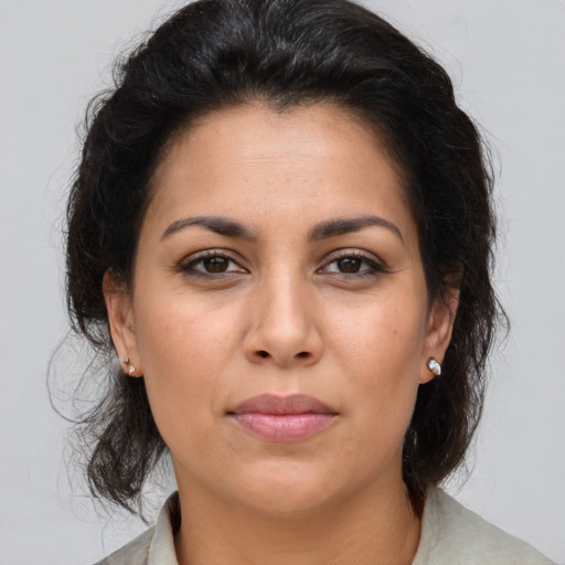 Joyful latino young-adult female with medium  brown hair and brown eyes