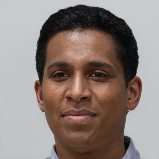 Joyful latino adult male with short  black hair and brown eyes
