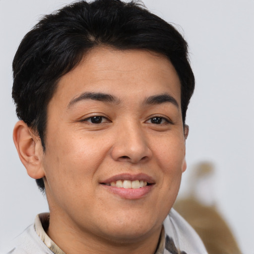 Joyful asian young-adult male with short  brown hair and brown eyes