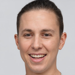 Joyful white young-adult male with short  brown hair and brown eyes