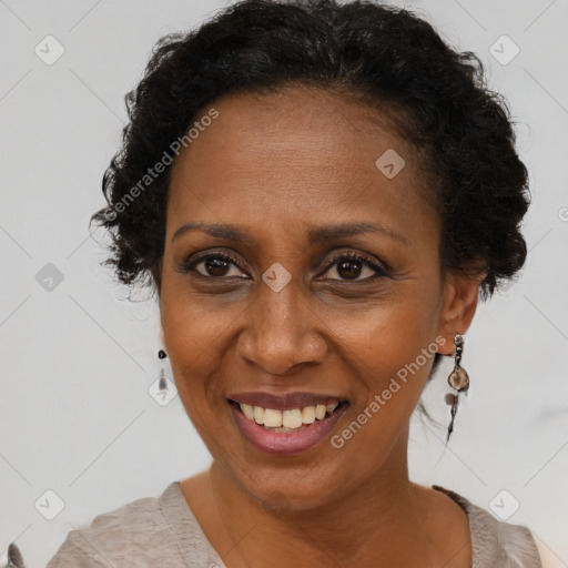 Joyful black adult female with short  brown hair and brown eyes