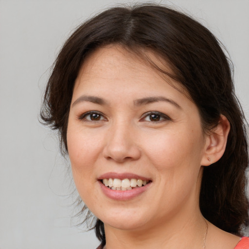 Joyful white young-adult female with medium  brown hair and brown eyes
