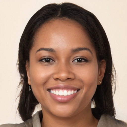 Joyful latino young-adult female with long  brown hair and brown eyes