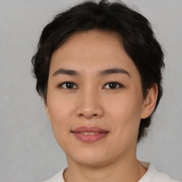 Joyful asian young-adult female with short  brown hair and brown eyes