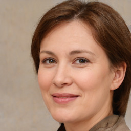 Joyful white adult female with medium  brown hair and brown eyes