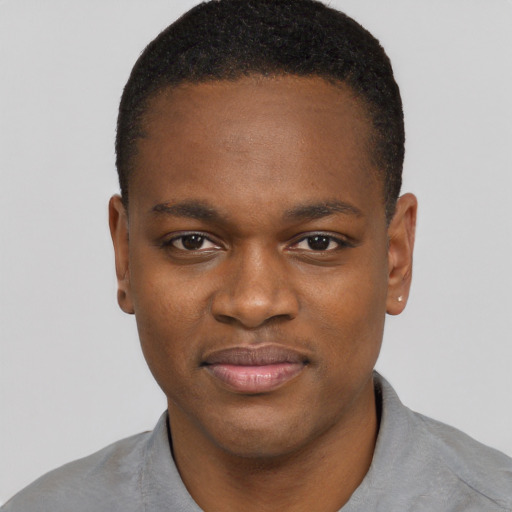 Joyful black young-adult male with short  brown hair and brown eyes