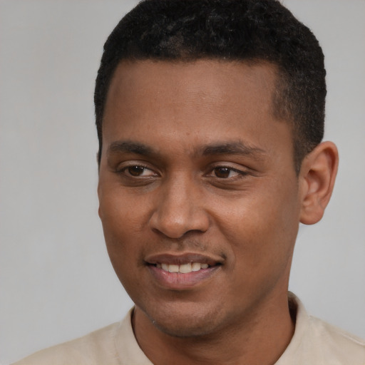 Joyful latino young-adult male with short  black hair and brown eyes