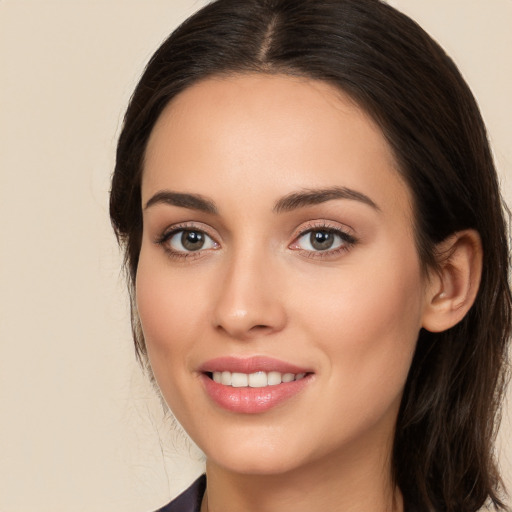 Joyful white young-adult female with long  brown hair and brown eyes