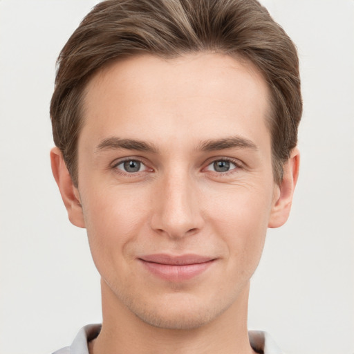 Joyful white young-adult male with short  brown hair and grey eyes