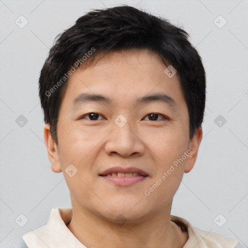 Joyful asian young-adult male with short  black hair and brown eyes