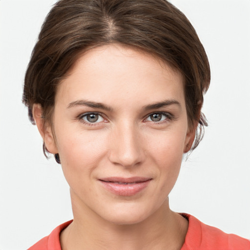 Joyful white young-adult female with short  brown hair and grey eyes