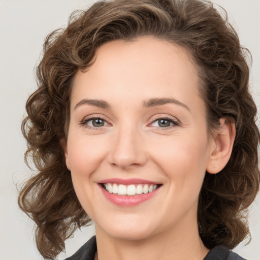 Joyful white young-adult female with medium  brown hair and green eyes