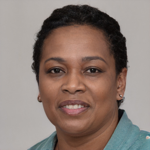 Joyful black young-adult female with short  brown hair and brown eyes